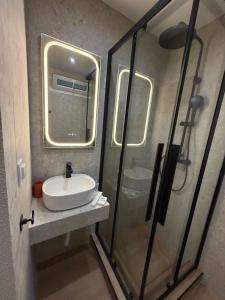 a bathroom with a sink and a glass shower at DD apartments & suites in Paralia Katerinis +43 photos