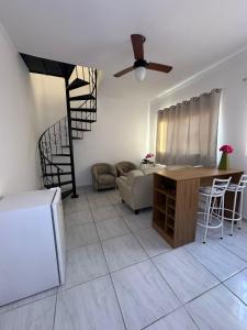 a living room with a staircase and a couch and a table at Apartamento Tio Du in Sorocaba