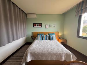 a bedroom with a bed with blue walls and a window at Batroun Escape, 2BR, 24-7 elect, beach view! in Batroûn