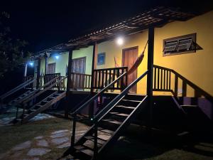 a house with stairs leading up to it at night at Pousada Recanto Guará Oficial in Pirenópolis