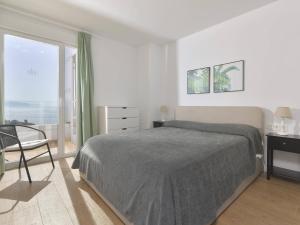 a white bedroom with a bed and a window at Apartamento de lujo vista mar en Torrox Costa in Torrox Costa
