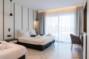 a hotel room with two beds and a large window at Oros Paradise Hotel in Pastida +14 photos