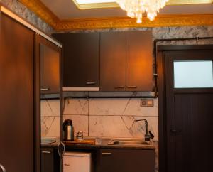 a kitchen with brown cabinets and a counter top at Golden Horn Life Hotel- FULL BOARD in Istanbul