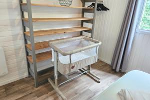 a shelf in a tiny house with a basket on it at CHALET ARDENTARDENNE - Durbuy in Durbuy +14 photos