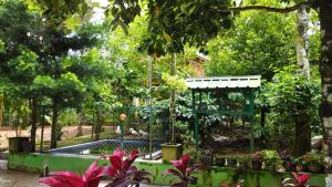 a garden with a fountain in the middle at Misty Slope in Ambalavayal +1 photo