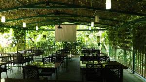 a patio with tables and chairs and ailion with lights at Misty Slope in Ambalavayal