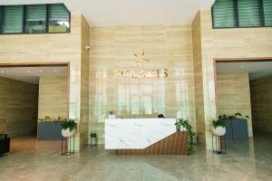 a lobby of a hotel with a reception desk in it at Solaris Executive Suites Osu Pool Gym in Accra +29 photos