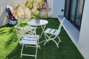 a patio with a table and two chairs on the grass at 2bd Tulum Country ClubPGA golfMid termgrocery in Akumal +100 photos