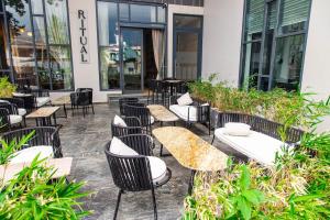 a group of tables and chairs in front of a building at Solaris Executive Suites Osu Pool Gym in Accra