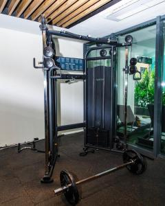 a gym with a barbell in front of a building at Solaris Executive Suites Osu Pool Gym in Accra