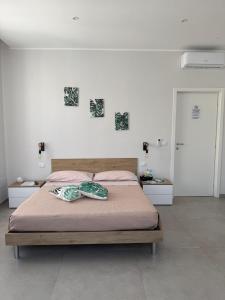 a bedroom with a bed with a blanket on it at Le Palme - Holiday Home in Brindisi