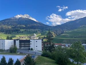a small town with a mountain in the background at Tgesa Tgampi T20 in Savognin