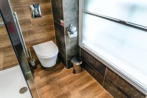 a bathroom with a toilet and a shower stall at The George Hotel in Penrith +84 photos