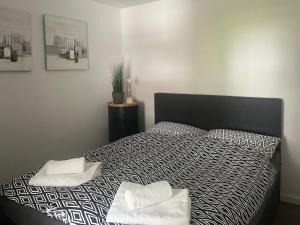 a bedroom with a bed with two towels on it at Tgesa Tgampi T20 in Savognin +12 photos
