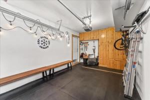 a living room with a bench and a bike on the wall at Cozy Hillside Cottage Overlooking Main Street in Park City