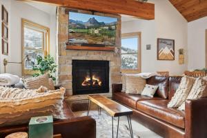 a living room with a couch and a fireplace at Cozy Hillside Cottage Overlooking Main Street in Park City