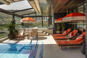 a swimming pool with orange chairs and a pool at DDK Collection Hotel in Duhok