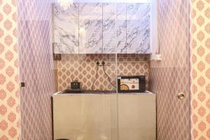 a kitchen with a counter and a cabinet with a microwave at Amara Inn by Sandane Homes Near Expo mart and Pari Chowk in Greater Noida