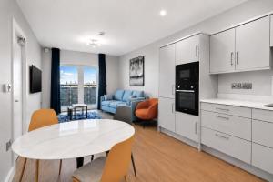 a kitchen and living room with a table and chairs at The Maltings in Portlaoise