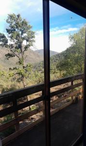 a view from a window of a mountain view at Cabaña Ecologica Huinganes in Machalí +15 photos