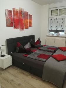 a bedroom with a bed with red pillows on it at Lindenblüte in Seehausen