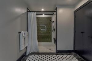 a bathroom with a shower with a glass door at Hotel Biloxi in Biloxi
