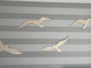 a group of birds flying on a striped background at Eastside 2 am Kurpark in Scharbeutz