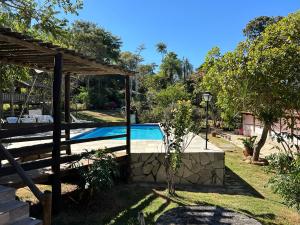 a pool in the backyard of a house at Pousada Recanto Guará Oficial in Pirenópolis
