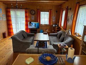 a living room with two chairs and a table at Alga in Mrzeżyno