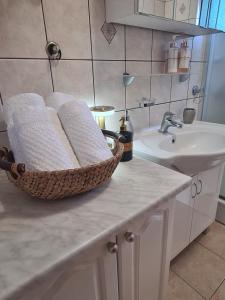 a bathroom with a sink and a basket of towels at Kuća za odmor Virgo in Opanci +42 photos