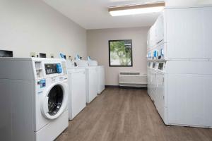 a laundry room with white washers and dryers at Extended Stay America - Providence - West Warwick in West Warwick