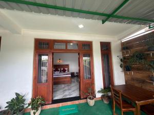 a room with a wooden door and a bedroom at Duo Haven Inn Ella in Ella