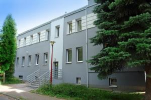 a gray building with a tree in front of it at Greyhouse in Jaworzno +3 photos