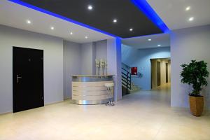 a lobby with a bar with a blue lighting at Greyhouse in Jaworzno