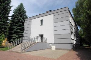 a white building with stairs on the side of it at Greyhouse in Jaworzno