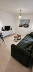 a living room with a couch and a table at Apartmán na Rohu II in Malacky