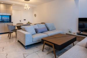 a living room with a couch and a table at Oros Paradise Hotel in Pastida