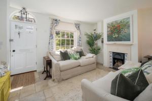 a living room with two couches and a fireplace at Christmas Cottage in Yarmouth