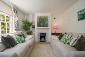 a living room with two couches and a fireplace at Christmas Cottage in Yarmouth