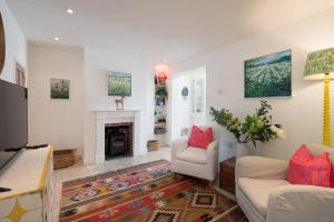 a living room with a couch and a fireplace at Christmas Cottage in Yarmouth