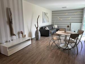 a living room with a table and a couch at Eastside 2 am Kurpark in Scharbeutz +33 photos