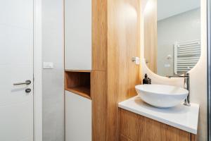 a bathroom with a bowl sink and a mirror at Boho Apartment with Sea View & Pool in Baošići +35 photos