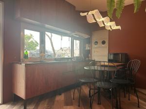 a kitchen with a counter and a table and chairs at 上水民宿 in Chiayi City +4 photos