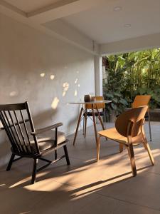 two chairs and a table on a patio at 2 Bed & 2 Bath Suite, 5th floor in Ban Bang Toei (1)