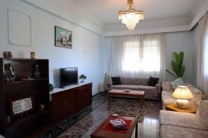 a living room with a couch and a table at Sea view apartment in Plomari