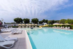 a large swimming pool with chairs and a slide at Club del Sole Le Palme Lazise Family Collection in Lazise +114 photos