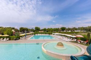 a pool at a resort with a hat on it at Club del Sole Le Palme Lazise Family Collection in Lazise