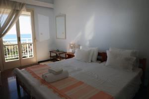 a bedroom with a large bed with a view of the ocean at Sea view apartment in Plomari