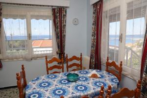 a dining room with a table with a view of the ocean at Sea view apartment in Plomari