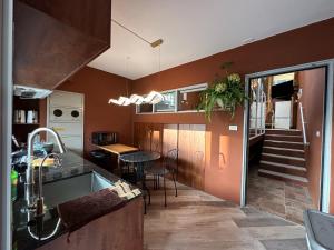 a kitchen with a sink and a dining room at 上水民宿 in Chiayi City